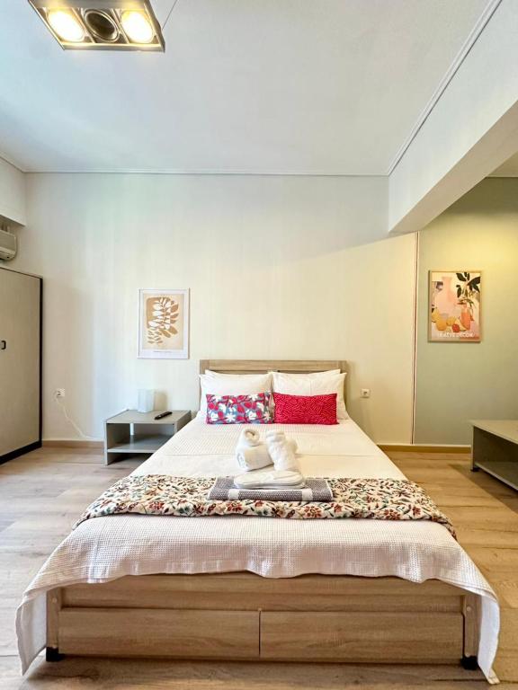 a bedroom with a large bed with a stuffed animal on it at Alpha - City Center Rooms Athens in Athens