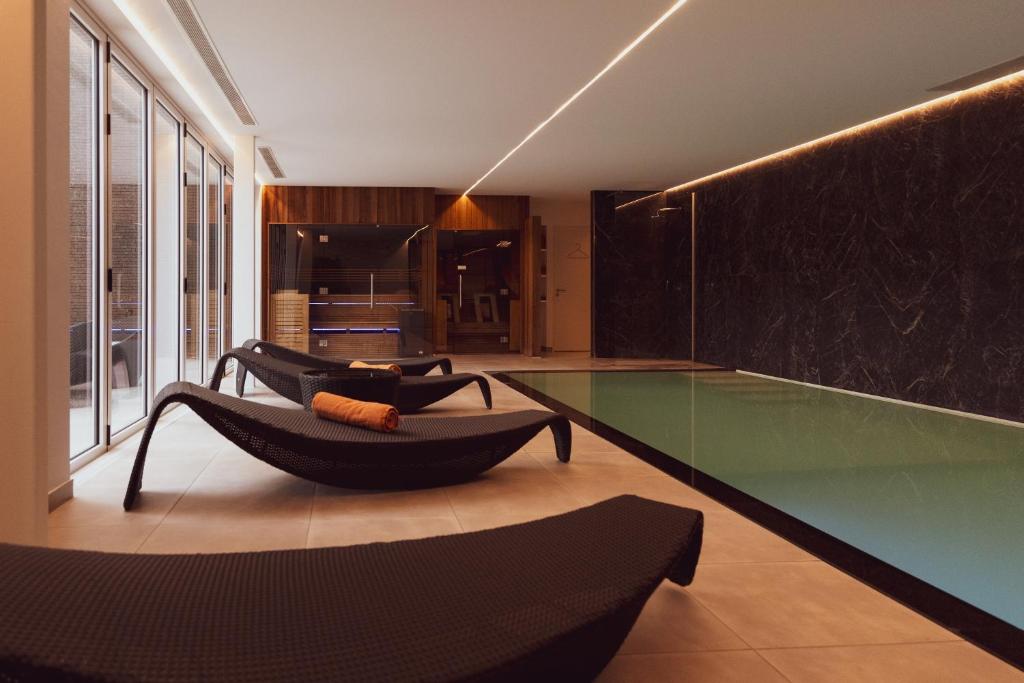 a living room with a glass table and chairs at Huyze Fox - Boutique Stays in Bruges
