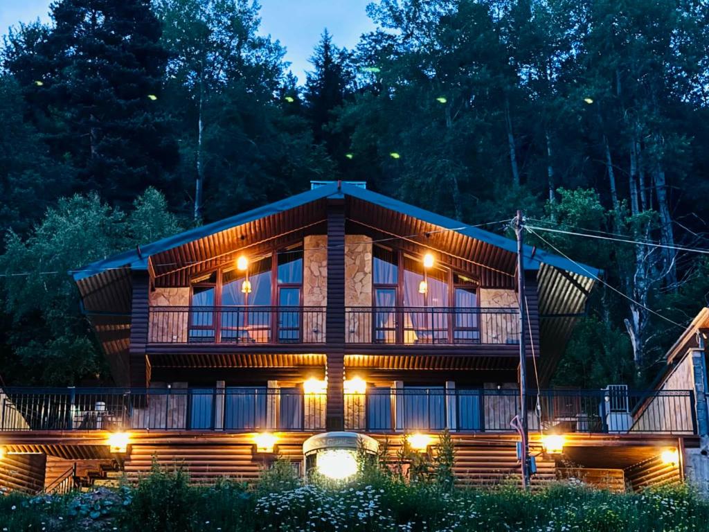 a log cabin at night with lights at The Grand Hotel Bakuriani in Bakuriani