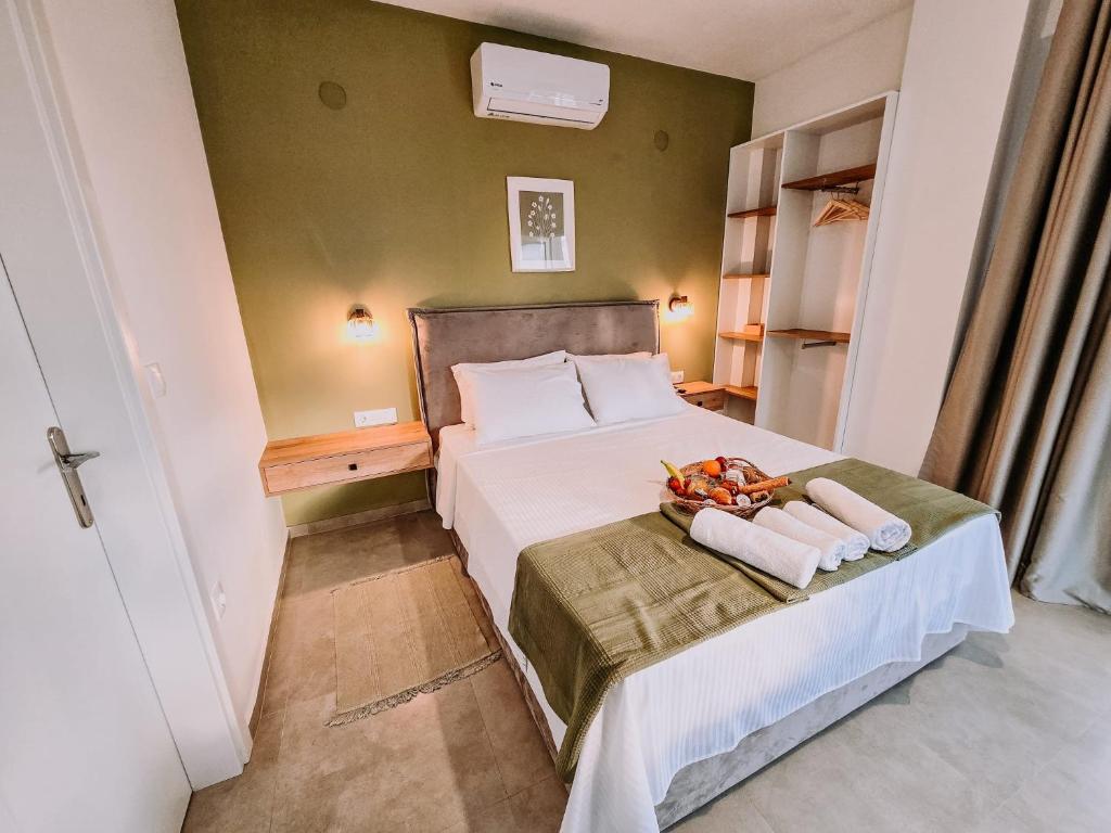 a bedroom with a bed with towels on it at Meraki Nikiti in Nikiti