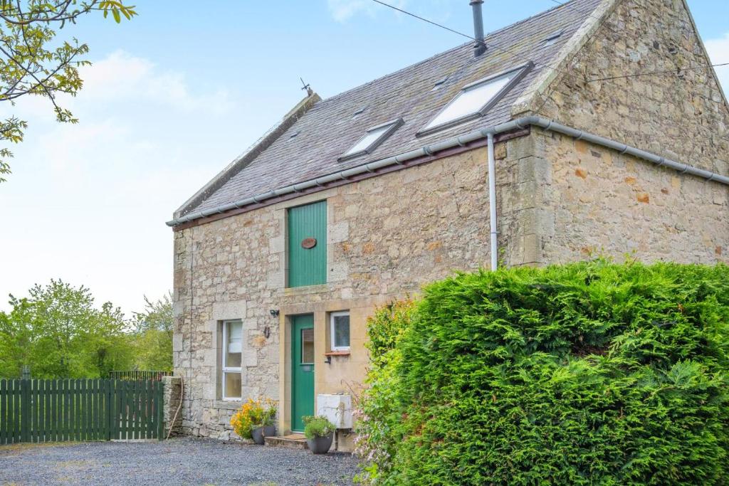 an old stone house with a green door at 3 Bed in Coldstream oc-c39085 in Coldstream