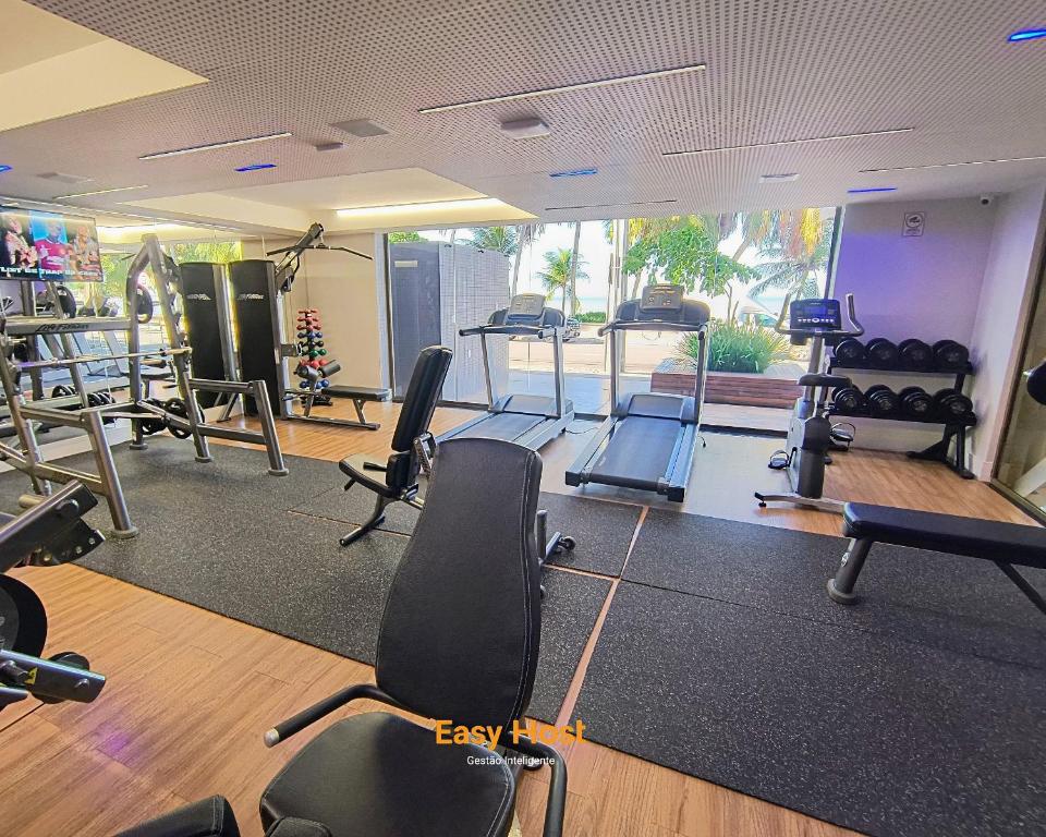 a gym with several treadmills and exercise bikes at Flats Unity Cabo Branco - By EasyHost in João Pessoa
