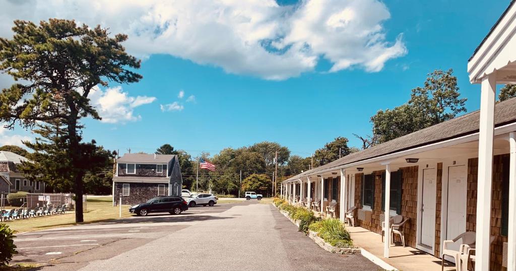 a street in a small town with cars parked on the road at The Chatham Motel in Chatham