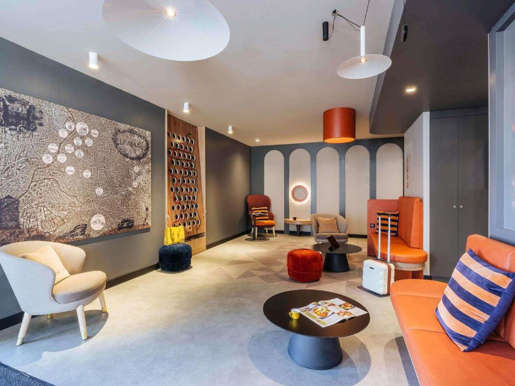 a living room with a couch and chairs and a table at ibis Styles Le Mans Gare Sud in Le Mans