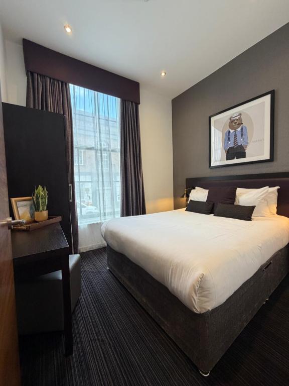 a hotel room with a large bed and a window at EPIC Apart Hotel, Duke Street, Central Liverpool Apartments Near Liverpool ONE in Liverpool