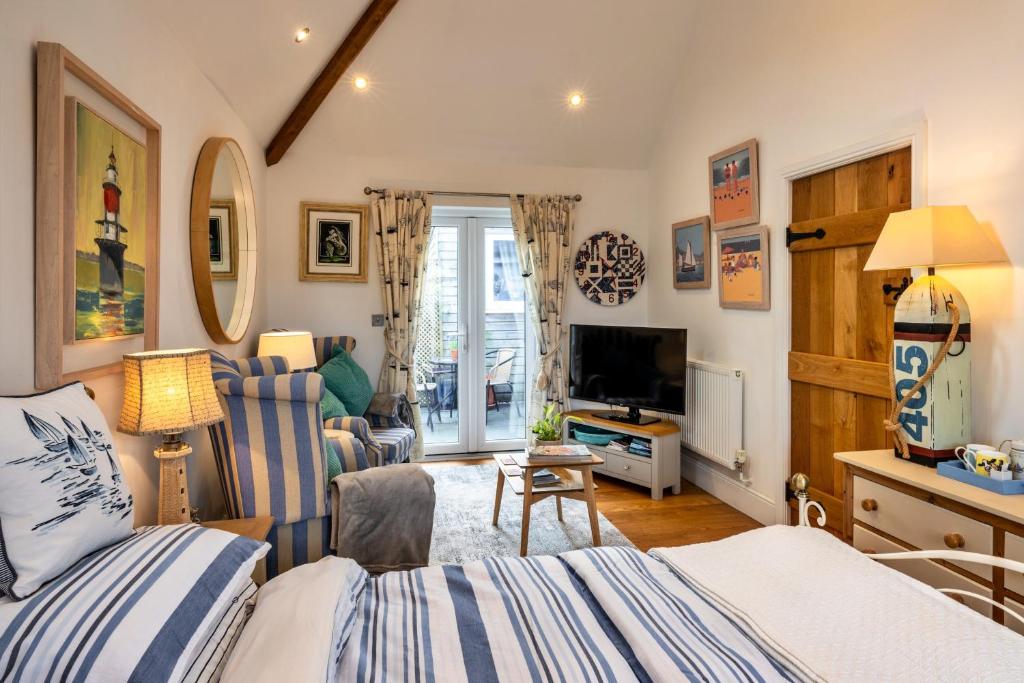 a bedroom with a bed and a living room at Finest Retreats - The Rectory Nook Annexe in Saint Teath