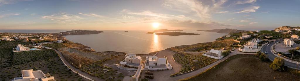 an aerial view of a city and a body of water at Agia Marina Caldera suites in Megalochori