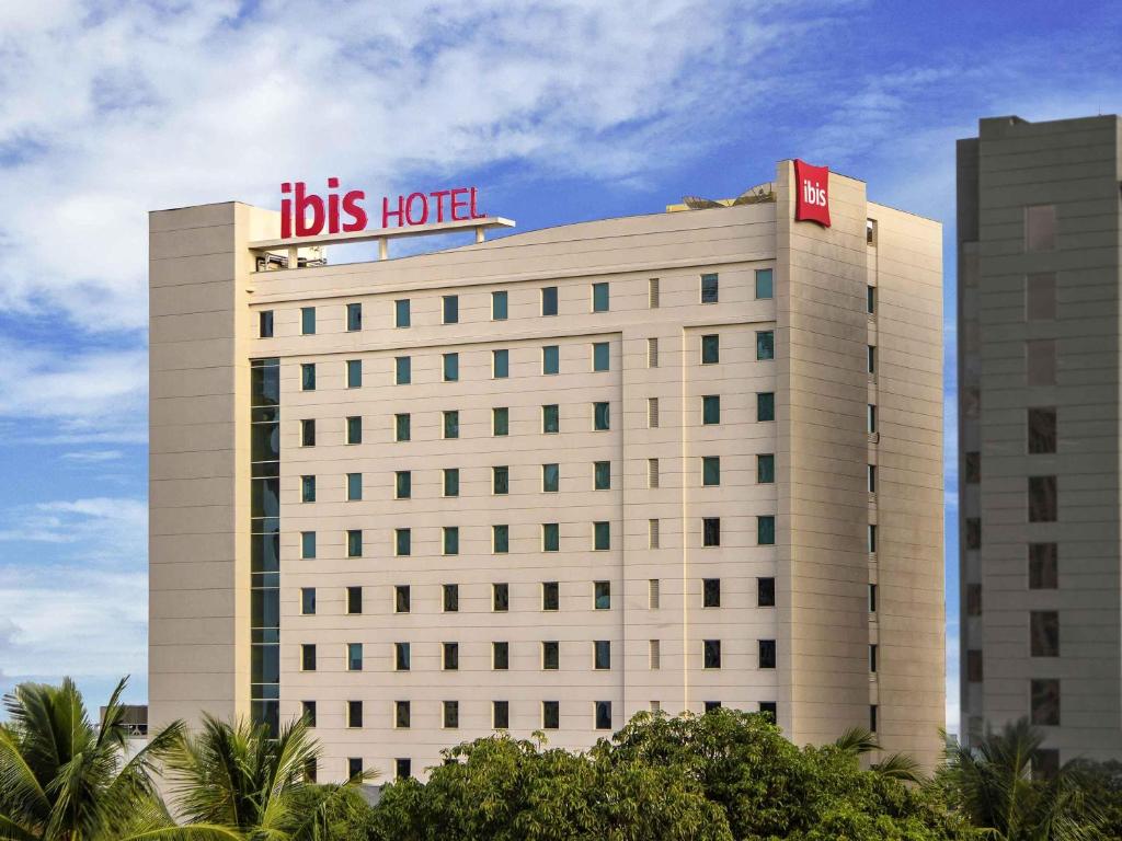 a big building with a sign on top of it at ibis Chennai Sipcot - An Accor Brand in Chennai