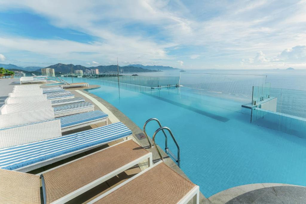 a swimming pool with blue water in the ocean at The Zenix Hotel Seaview in Nha Trang