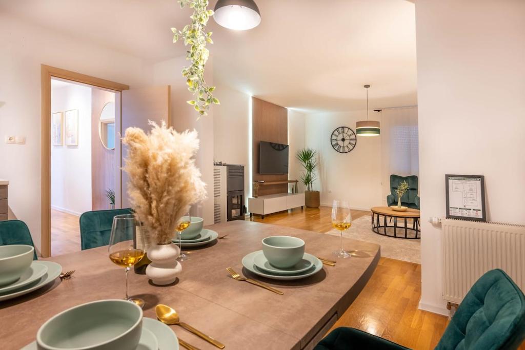 a dining room and living room with a table and chairs at Aurea Lika - Gospic in Gospić