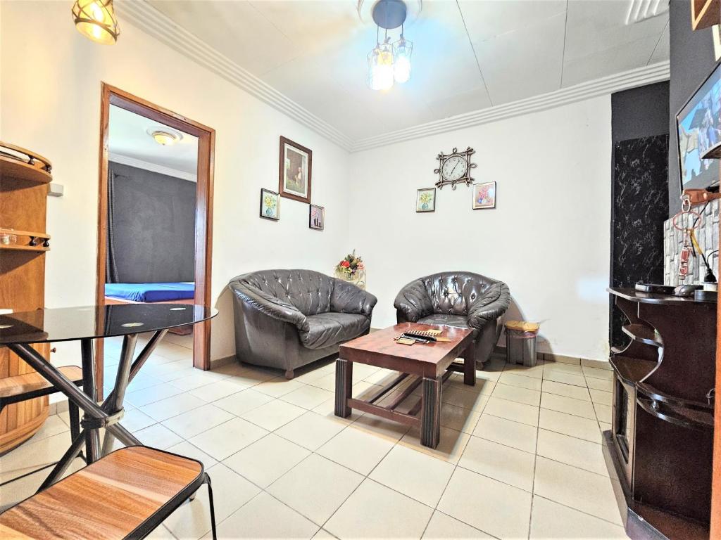 a living room with couches and a table at The Yafé Bastos 6 in Yaoundé