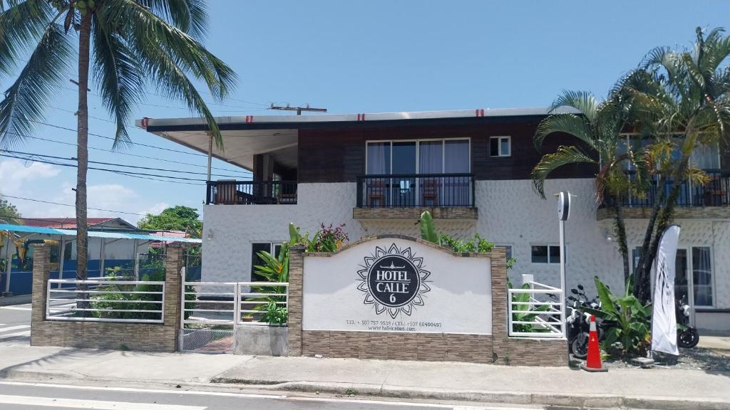 a building with a sign for a surf club at Hotel Calle 6 in Bocas Town