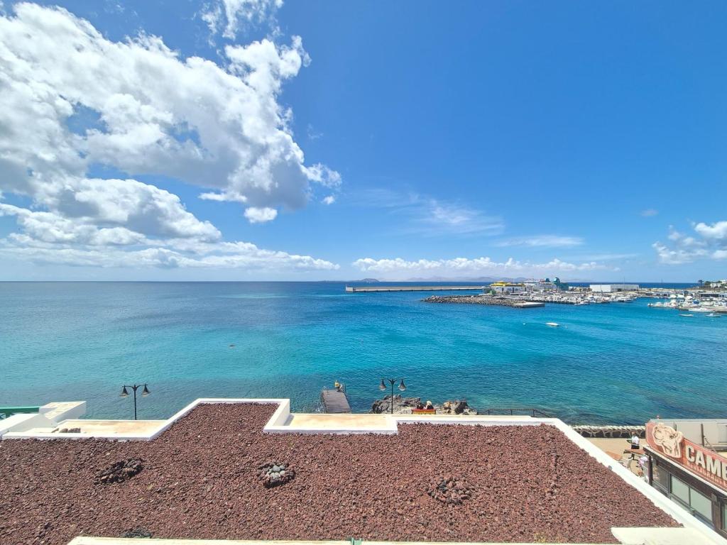 a view of the ocean from a building at Casa Balcón del Puerto in Playa Blanca