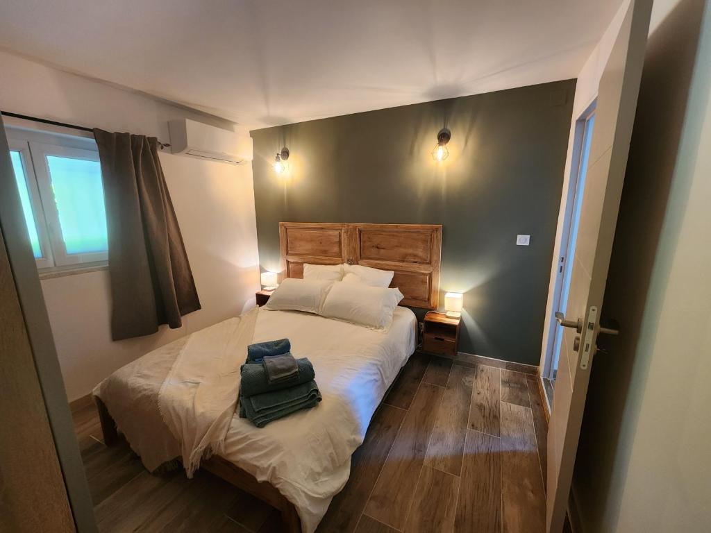 a bedroom with a bed with two bags on it at Une escapade en Provence in Pertuis