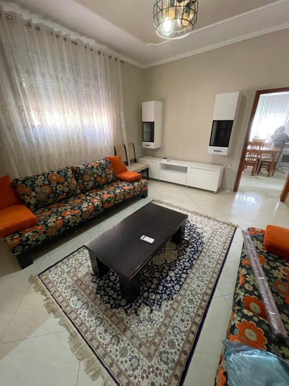 a living room with a couch and a coffee table at Flag's Square House Vlore in Vlorë
