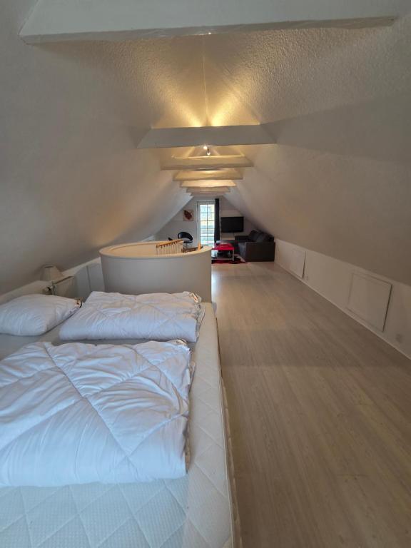 a bedroom with a large white bed in a room at Marku House 2-plans huse in Struer