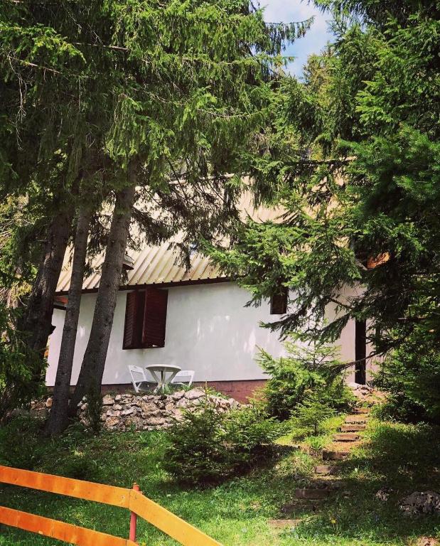 a white building with a table in front of it at Black Lake House Dajovic in Žabljak
