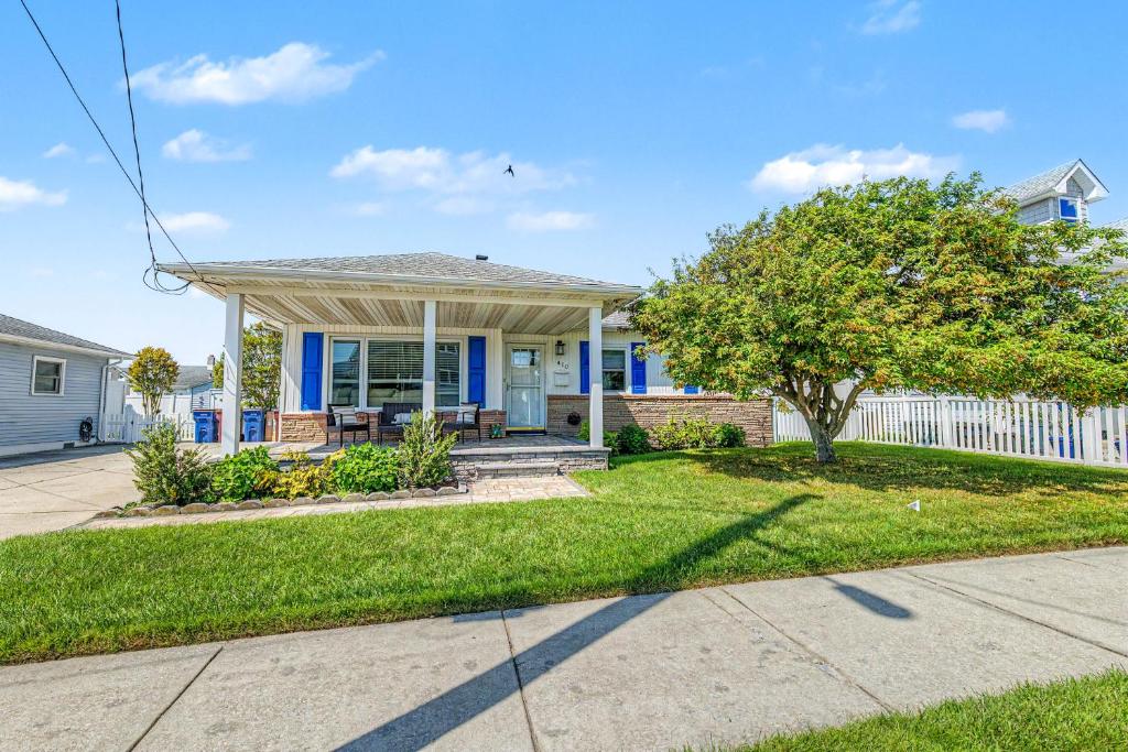 a home with a white fence and a yard at Shore Escape Steps to the Beach in Ventnor City