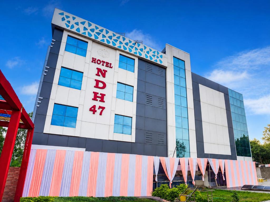 a building with a sign on the front of it at Hotel NDH 47 in Korādih