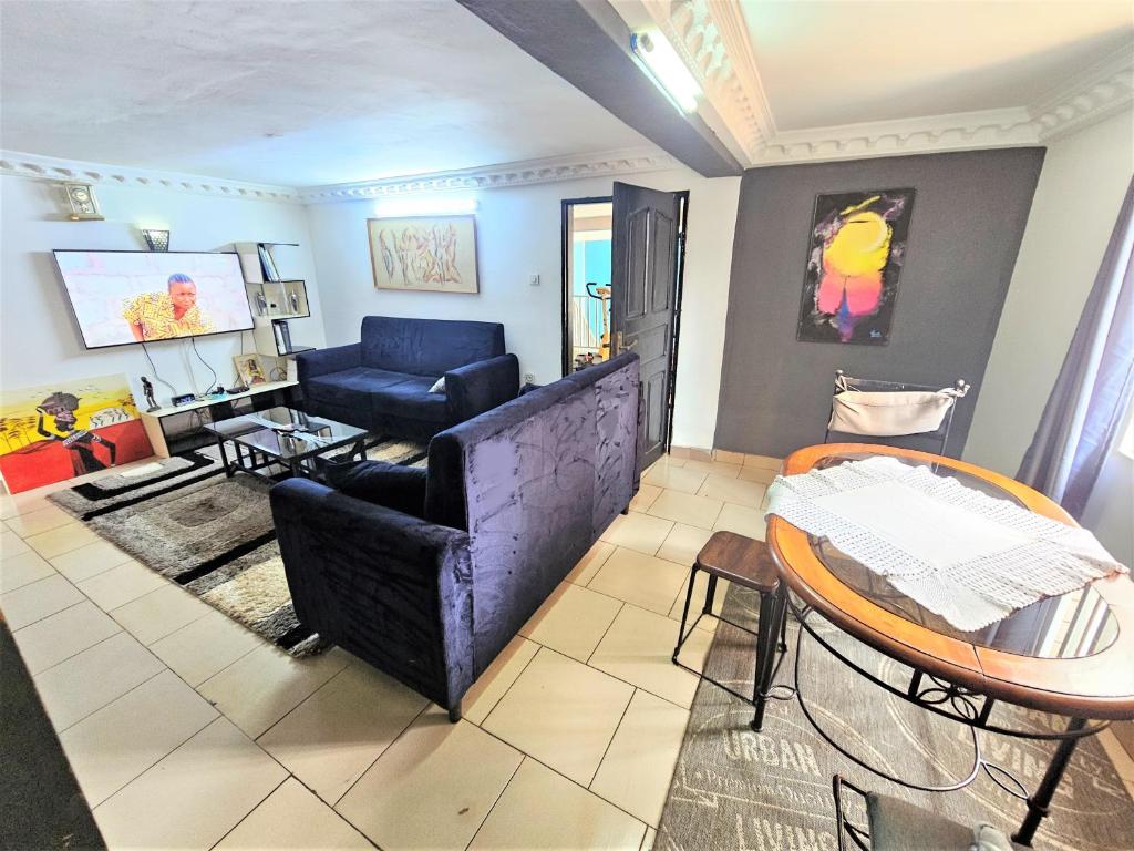 a living room with a couch and a table at The Yafé Bastos 9 in Yaoundé