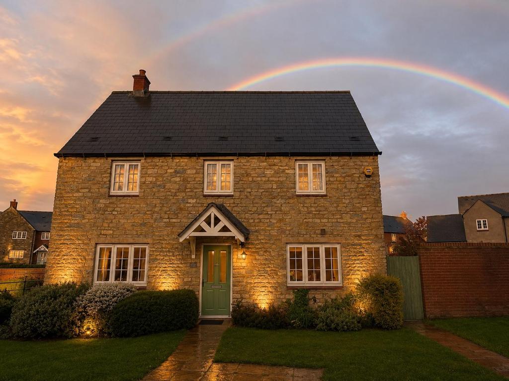 a rainbow over a brick house with at Silverstone Paddock Retreat in Silverstone