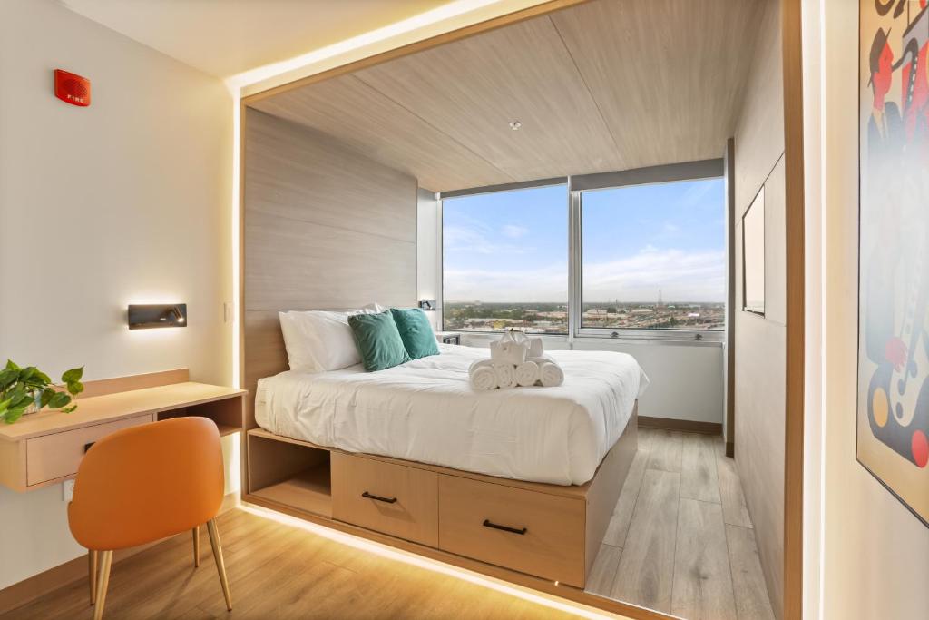 a bedroom with a bed with a large window at VCAY Hotel 5BR 5BA Group Suite Near Superdome in New Orleans