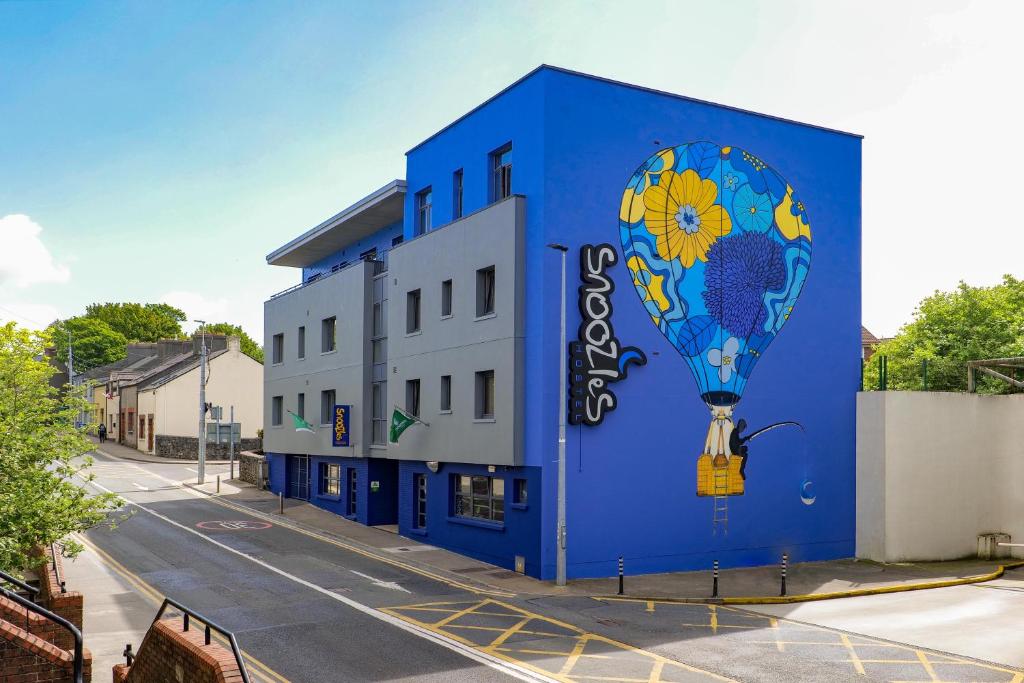 a blue building with a painting of a hot air balloon at Snoozles Galway City Centre in Galway