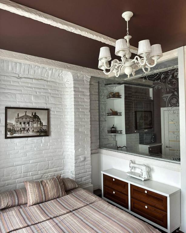 a bedroom with a bed and a sink and a mirror at VIP apartment 40 in Lviv