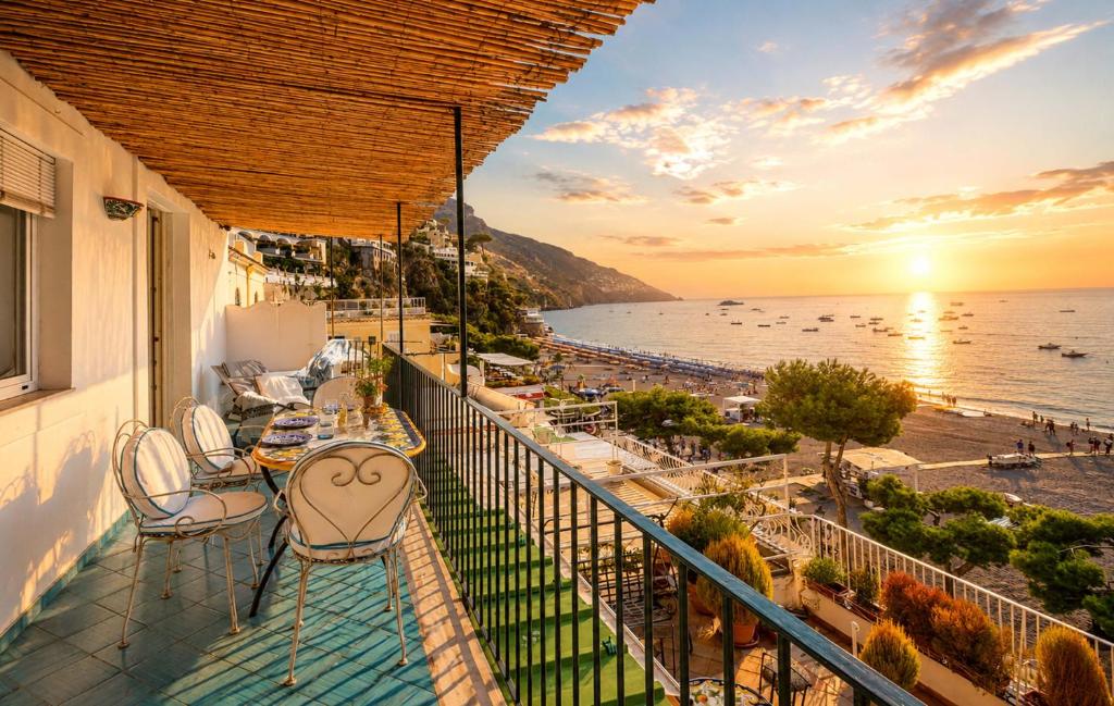 a balcony with chairs and a view of the ocean at AMORE RENTALS - Casa Raffi in Positano