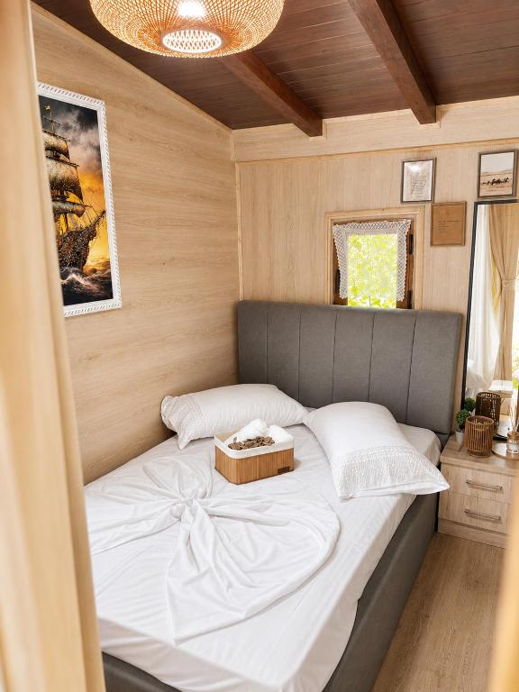 a bedroom with a bed with a box on it at Eagle Park&Camping in Bajkaj