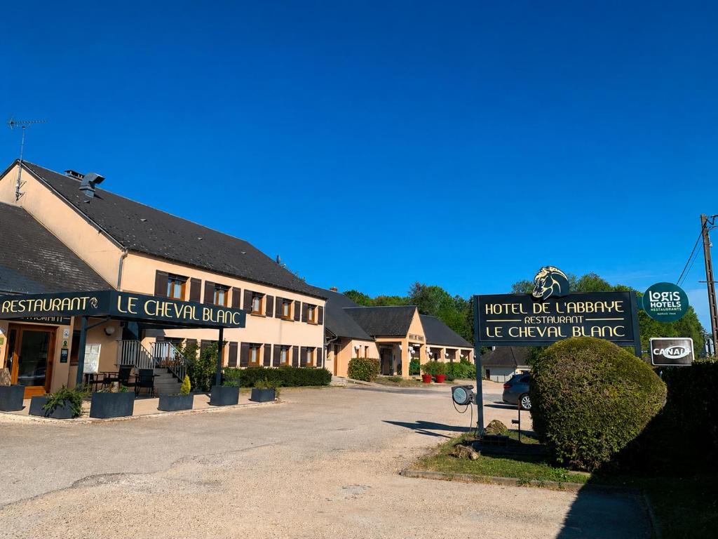 a street sign in front of a building at Logis Hotel Restaurant de l'Abbaye in Ferrières