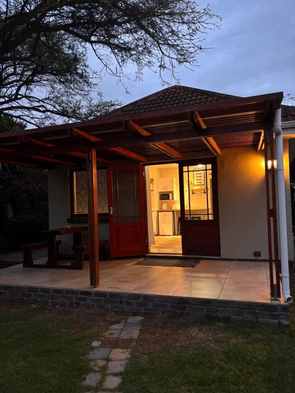 a pavilion with a table on a patio at Cottage Hill in Gqeberha