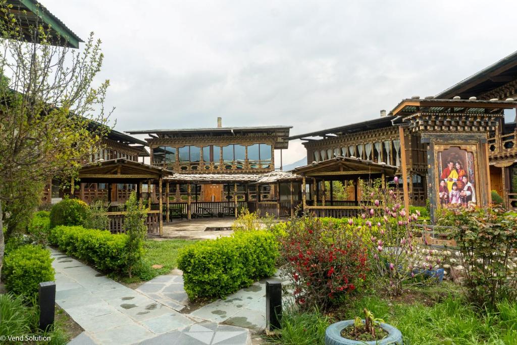 a building with a garden in front of it at Phuntsho Guest House in Jakar