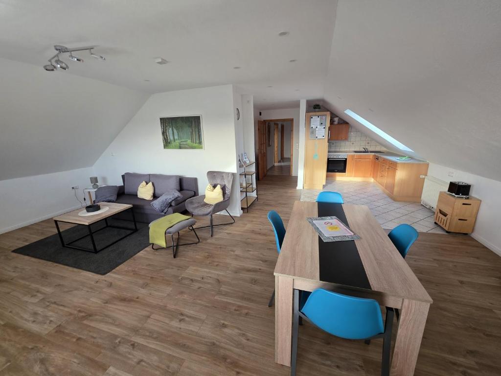 a living room with a table and a couch at FeWo Weitblick in Sassenburg