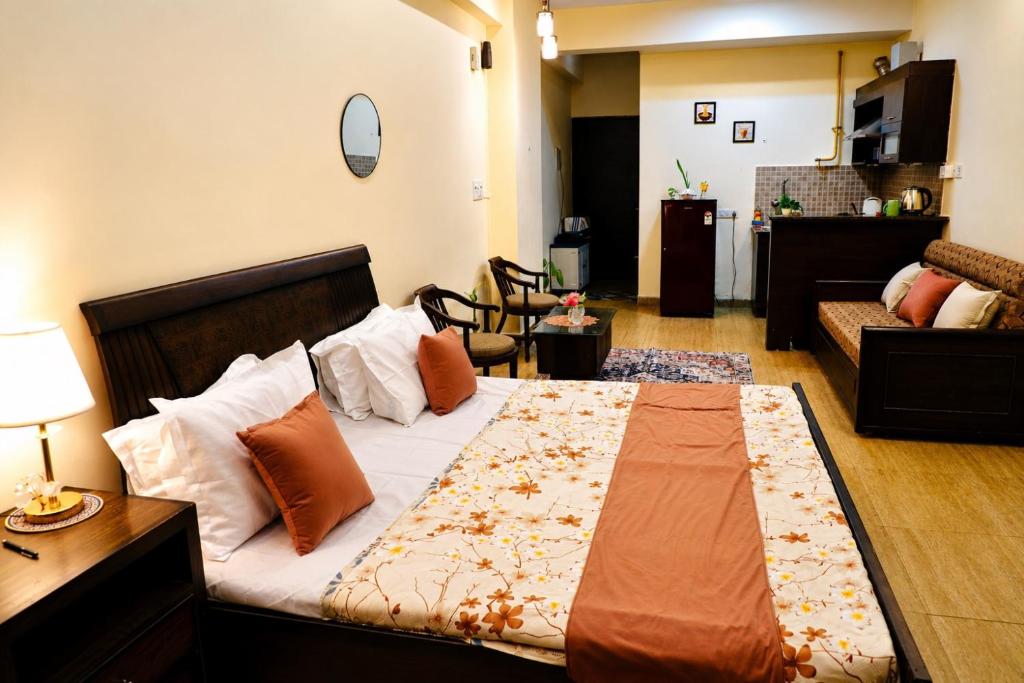 a bedroom with a bed and a living room at The Moksh in Haridwār