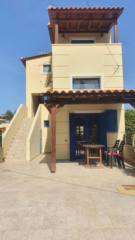 a house with a table in front of it at LifeHouse in Agia Pelagia