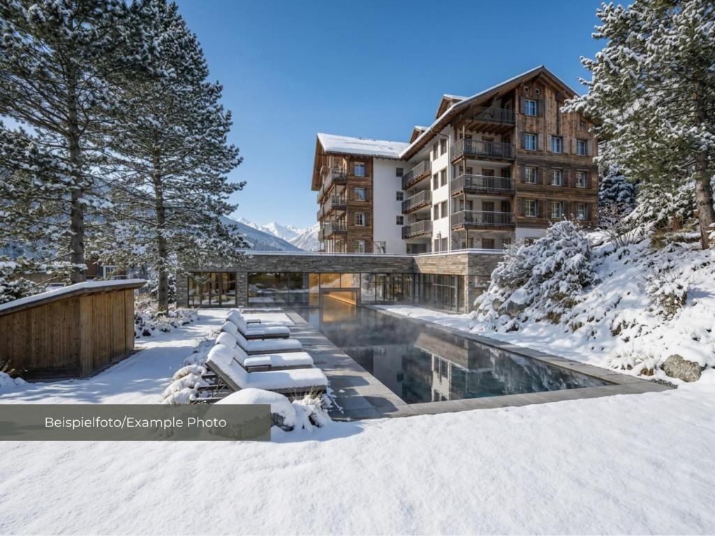 a hotel in the snow with a pool at VAYA Post Montafon - Neueröffnung Dezember 2026 in Gaschurn
