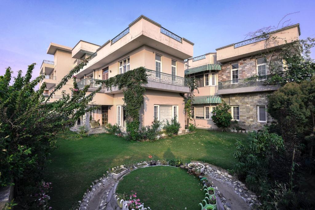 a large building with a garden in front of it at IT City Luxe Homestay-Secure & Comfortable Stay in Mohali in Mohali