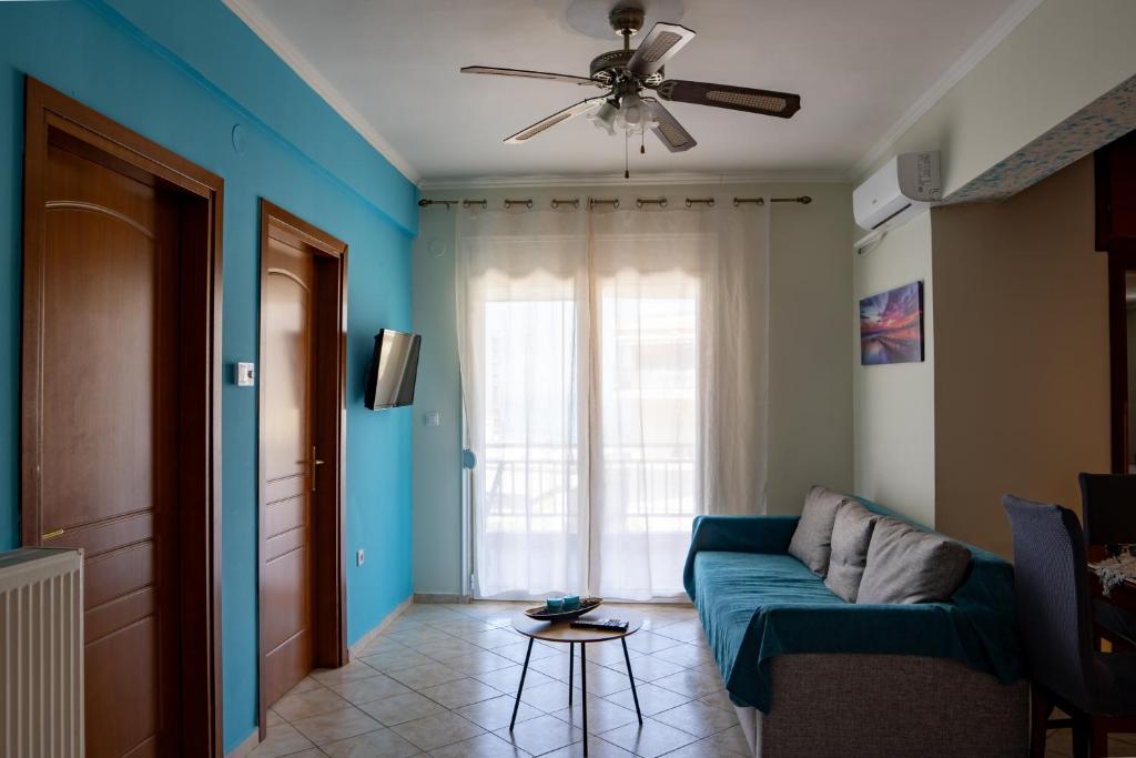a living room with a couch and a ceiling fan at Maria Apartments in Perea