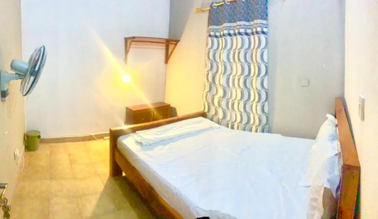 a bedroom with a bed in a room at Zen villa in Old Yundum
