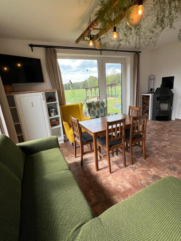 a living room with a wooden table and chairs at Ubytování u Kotrbů in Suchdol nad Lužnicí