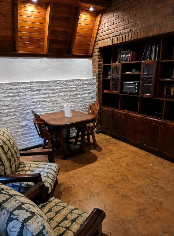 a dining room with a table and a couch at Monoambiente in Ezpeleta