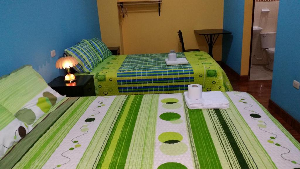 Postel nebo postele na pokoji v ubytování Hostal Los Pinos