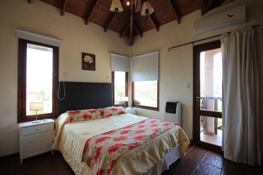 a bedroom with a bed and two windows at Complejo Ayenué & Spa in Ostende
