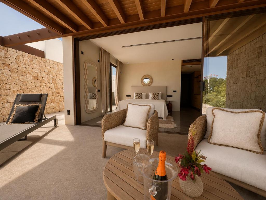 a bedroom in a villa with a bed and a table at Can Skye in Sant Carles de Peralta