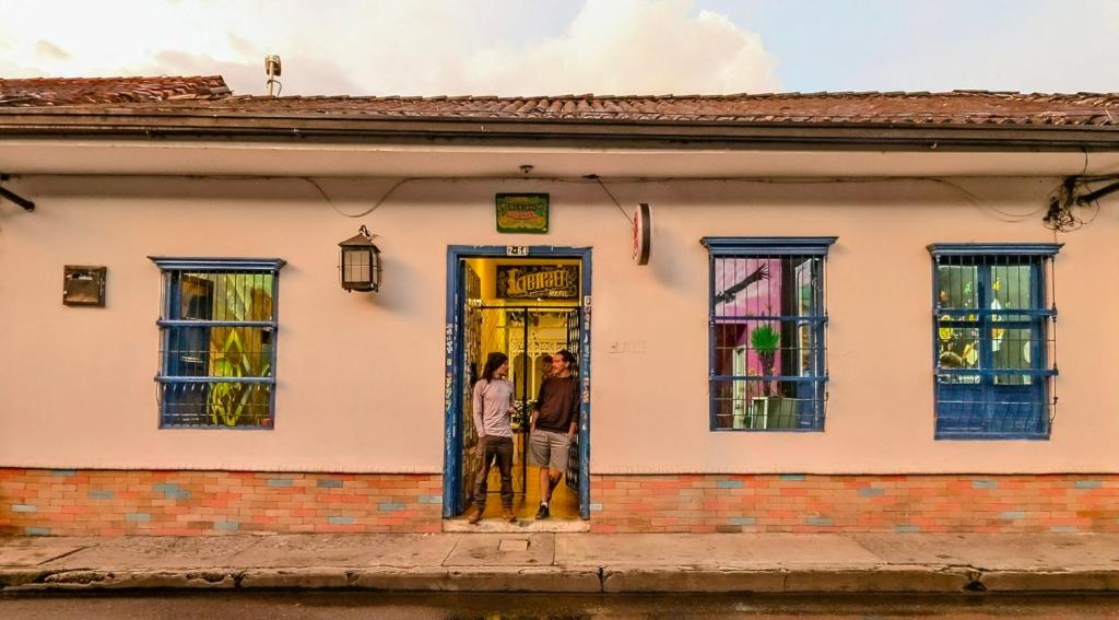two people standing in the door of a house at Lienzo Hostal Popayán in Popayan