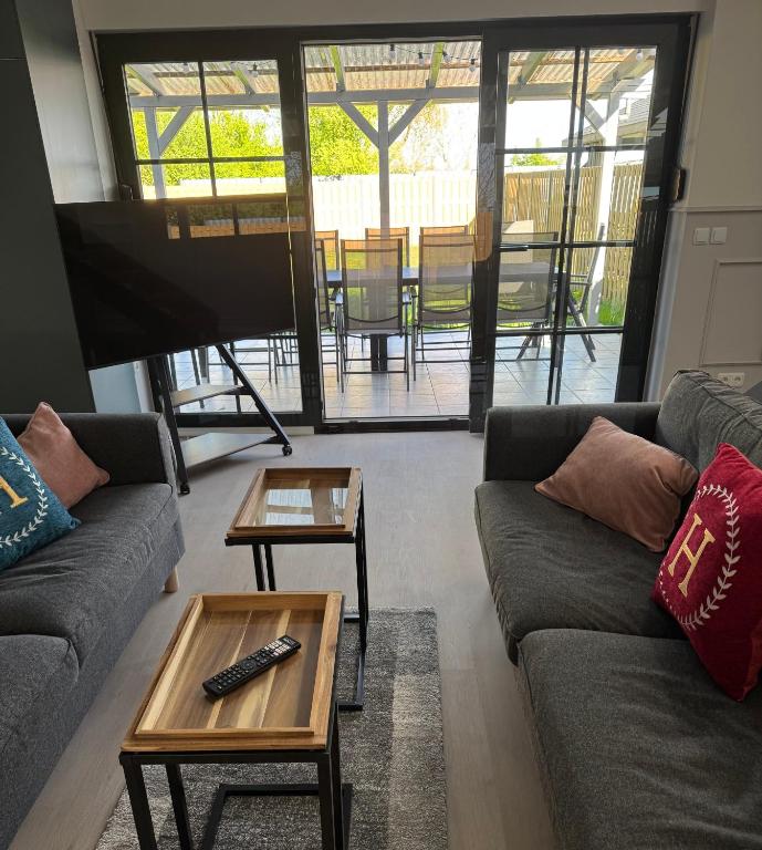 a living room with two couches and a table at Ferienhaus 26 Bernd mit 10-Schlafzimmer in Greifswald in Heilgeisthof