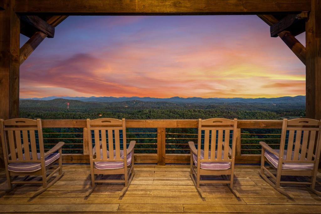 a room with chairs on a porch with a view at Sky's the Limit in Mineral Bluff