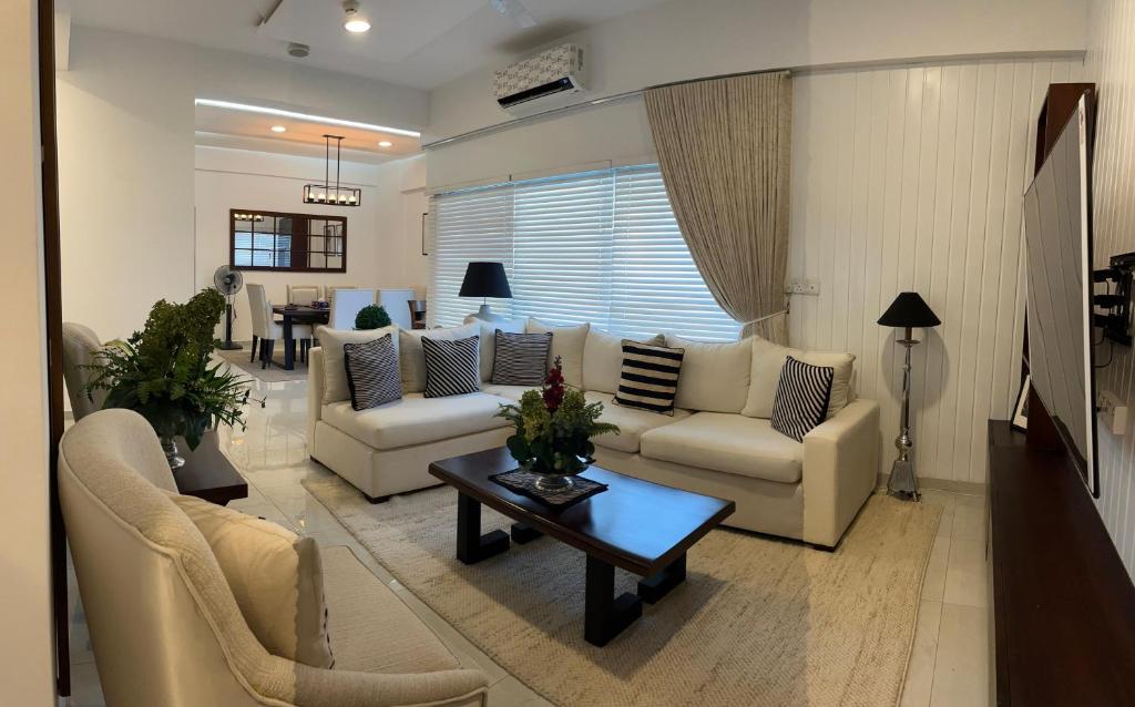 a living room with couches and a coffee table at Iconic Galaxy in Rajagiriya
