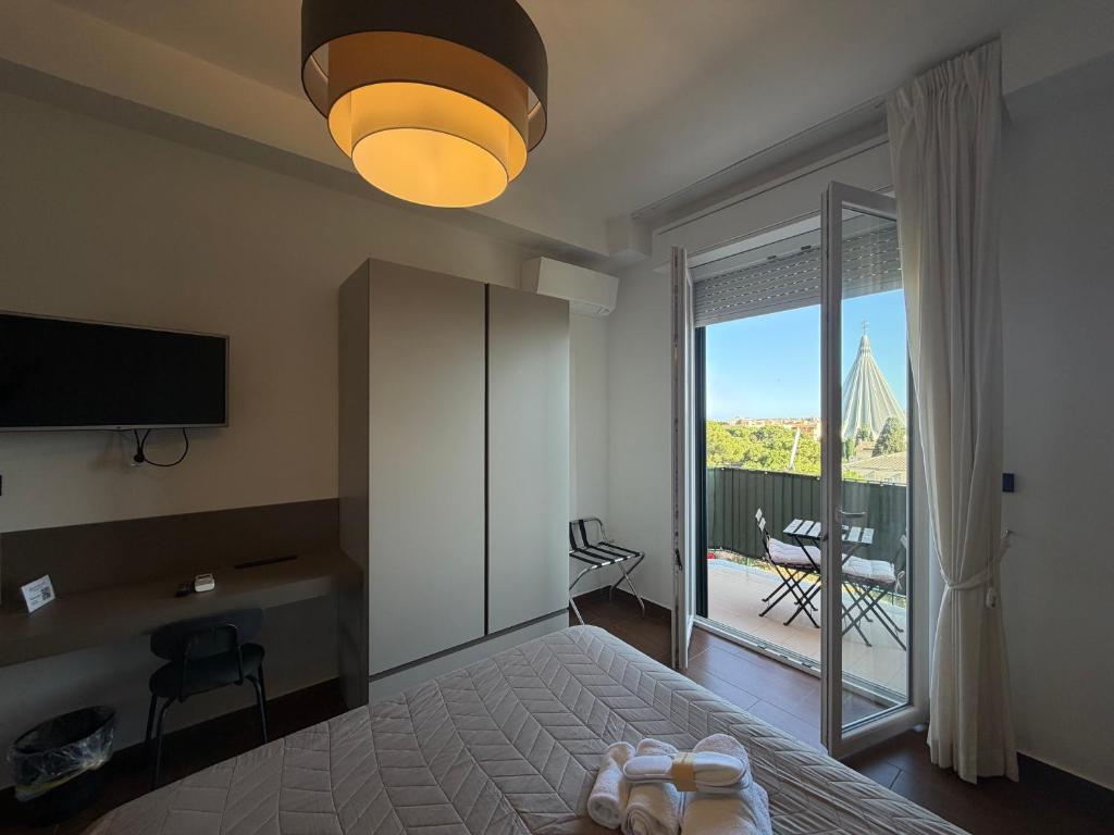a bedroom with a bed and a sliding glass door at Panoramic Rooms in Syracuse